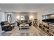Inviting living room featuring wood floors, plush seating, decorative lighting, and a rocking chair at 402 Merlin Ct, Brandon, FL 33510