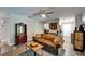 Comfortable living room featuring modern furnishings, wood floors, and a decorative ceiling fan at 402 Merlin Ct, Brandon, FL 33510