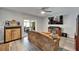 Bright living space leading to outdoor area, featuring entertainment center, ceiling fan, and wood floors at 402 Merlin Ct, Brandon, FL 33510