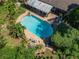 Aerial view of a private pool surrounded by lush landscaping and a brick patio with plenty of lounge seating at 402 Merlin Ct, Brandon, FL 33510