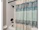 Clean white tiled shower with a blue patterned shower curtain at 402 Merlin Ct, Brandon, FL 33510