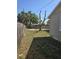 Backyard with a wooden fence and a tree in the middle at 4420 6Th S Ave, St Petersburg, FL 33711