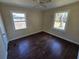 Cozy bedroom featuring two windows offering lots of natural light and hardwood flooring at 4420 6Th S Ave, St Petersburg, FL 33711