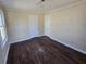 Bedroom with dark hardwood floors, two closets and baseboard trim at 4420 6Th S Ave, St Petersburg, FL 33711