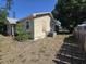 Side yard featuring grass, an air conditioner, and a wooden fence at 4420 6Th S Ave, St Petersburg, FL 33711