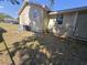 Exterior view of a home with an air conditioner and grass yard at 4420 6Th S Ave, St Petersburg, FL 33711