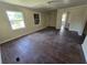 Spacious living room with original hardwood floors and plenty of natural light from large windows at 4420 6Th S Ave, St Petersburg, FL 33711