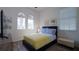 Inviting bedroom featuring a bed, bench, and arched windows for natural light at 443 Noble Faire Dr, Sun City Center, FL 33573