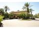 Attractive clubhouse featuring lush landscaping, well-kept grounds, and convenient golf cart parking at 443 Noble Faire Dr, Sun City Center, FL 33573