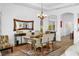 Elegant dining room featuring stylish furniture, chandelier, and hardwood flooring at 443 Noble Faire Dr, Sun City Center, FL 33573