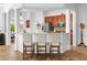 An open kitchen with a breakfast bar and modern stools, blending seamlessly into the home's living area at 443 Noble Faire Dr, Sun City Center, FL 33573