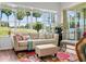 Bright living room with a large window offering serene golf course views, comfortable seating, and stylish decor at 443 Noble Faire Dr, Sun City Center, FL 33573