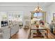 Bright living room with large windows offering picturesque views and comfortable seating at 443 Noble Faire Dr, Sun City Center, FL 33573