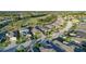 Aerial view of a residential neighborhood with well-maintained homes and lush landscaping at 443 Noble Faire Dr, Sun City Center, FL 33573