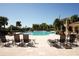 Relaxing pool area features inviting lounge chairs and well-maintained landscaping at 443 Noble Faire Dr, Sun City Center, FL 33573