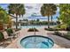 Inviting community pool and spa area is surrounded by lush landscaping and lounge chairs at 443 Noble Faire Dr, Sun City Center, FL 33573