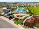 An aerial view shows a community pool, splash pad, and clubhouse at 4456 Globe Thistle Dr, Tampa, FL 33619