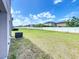 This spacious backyard is bordered by a white fence at 4456 Globe Thistle Dr, Tampa, FL 33619