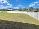 Spacious backyard with healthy lawn and white vinyl fence surrounding the property at 4456 Globe Thistle Dr, Tampa, FL 33619