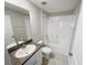 Neutral bathroom with vanity and granite countertop, tub and shower combo at 4456 Globe Thistle Dr, Tampa, FL 33619