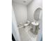 This is a powder room featuring a toilet and pedestal sink with a round mirror above at 4456 Globe Thistle Dr, Tampa, FL 33619
