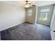 Bright bedroom featuring two windows, a ceiling fan, and a closet at 4456 Globe Thistle Dr, Tampa, FL 33619