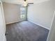 Bedroom showcasing neutral walls, a bright window, gray carpet, and white trim at 4456 Globe Thistle Dr, Tampa, FL 33619