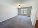 Spacious carpeted bedroom featuring a ceiling fan and window at 4456 Globe Thistle Dr, Tampa, FL 33619