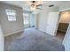 Well-lit bedroom featuring neutral walls and flooring, a ceiling fan and closet at 4456 Globe Thistle Dr, Tampa, FL 33619