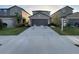 Exterior of home showcasing a two-car garage, driveway and well-maintained lawn at 4456 Globe Thistle Dr, Tampa, FL 33619