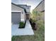 View of home's front entrance showcasing a walkway, landscape, and a brown front door at 4456 Globe Thistle Dr, Tampa, FL 33619