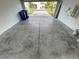 Spacious garage with a sealed concrete floor, leading out to the driveway and street at 4456 Globe Thistle Dr, Tampa, FL 33619