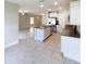 Open-concept kitchen with island, stainless steel appliances, and view of the living area at 4456 Globe Thistle Dr, Tampa, FL 33619