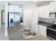 Modern kitchen with stainless steel appliances, granite countertops, and a view of the pantry at 4456 Globe Thistle Dr, Tampa, FL 33619