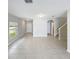 Open living area features tile flooring, large windows, and staircase access at 4456 Globe Thistle Dr, Tampa, FL 33619