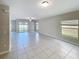 Bright living room with tile floors, sliding glass doors to the backyard, and neutral paint at 4456 Globe Thistle Dr, Tampa, FL 33619