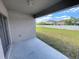 Covered patio area with a view of the backyard and white fence at 4456 Globe Thistle Dr, Tampa, FL 33619