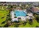 Aerial view of the community pool with ample seating, cabanas and lush landscaping at 4456 Globe Thistle Dr, Tampa, FL 33619
