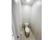 Powder room featuring a standard toilet, light tile flooring, and efficient use of space at 4456 Globe Thistle Dr, Tampa, FL 33619