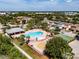 Community pool, playground, and basketball court in an aerial view, with neighborhood and city skyline at 4516 Savannah Holly Pl, Riverview, FL 33578