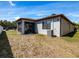 Exterior of a home displaying a screened in patio and spacious backyard at 4516 Savannah Holly Pl, Riverview, FL 33578
