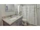 Charming bathroom featuring granite counters, wood-look flooring and shower-tub combo at 4516 Savannah Holly Pl, Riverview, FL 33578