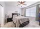 Serene bedroom with ceiling fan, window, and cozy bed with patterned quilt at 4516 Savannah Holly Pl, Riverview, FL 33578