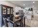 Dining area features wood floors, modern decor, and open kitchen concept at 4516 Savannah Holly Pl, Riverview, FL 33578