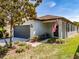 Charming single-Gathering home with a two-car garage and columned front porch and an American flag at 4516 Savannah Holly Pl, Riverview, FL 33578