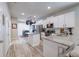 Open kitchen with stainless steel appliances, white cabinets, and a center island with granite countertops at 4516 Savannah Holly Pl, Riverview, FL 33578