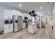 Open kitchen with stainless steel appliances, white cabinets, and a center island with granite countertops at 4516 Savannah Holly Pl, Riverview, FL 33578