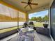 Relaxing screened patio complete with ceiling fan and views of the backyard at 4516 Savannah Holly Pl, Riverview, FL 33578