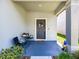 Welcoming front porch with seating, a wreath-adorned door, and neat landscaping at 4516 Savannah Holly Pl, Riverview, FL 33578