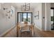 Elegant dining room with modern chandelier and sliding doors to outdoor pool area at 4575 Blue Star Ct, North Port, FL 34289